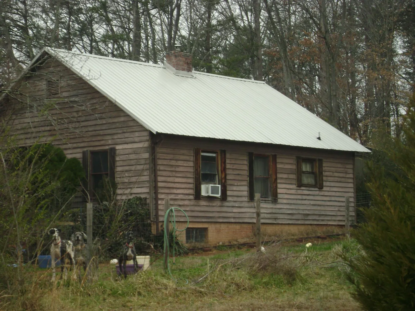 White metal roof on an old wood sided farmhouse, from a Metal Roof Installation job in Cowen